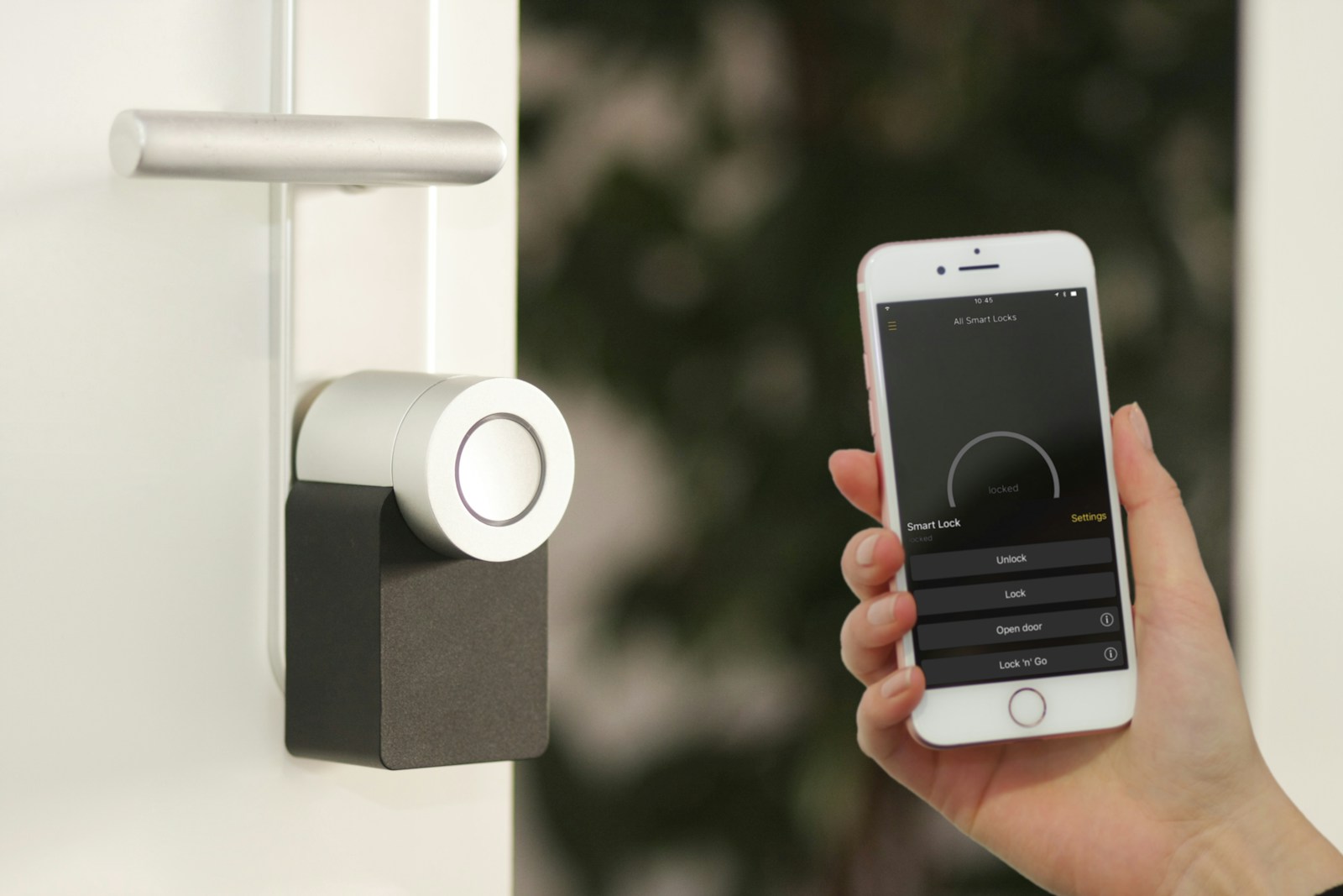 gold Apple iPhone smartphone home security system held at the door